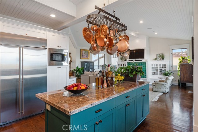 Granite island provides work space and storage + seating!  Cooking class anyone...?