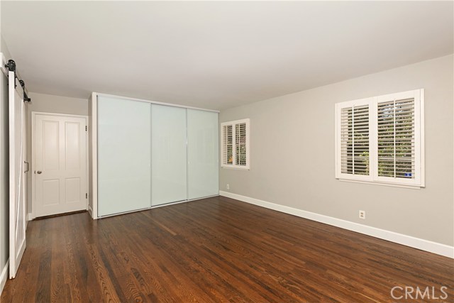 Master Bedroom with plantation shutters, custom sliding glass closet doors, and in-wall safe.