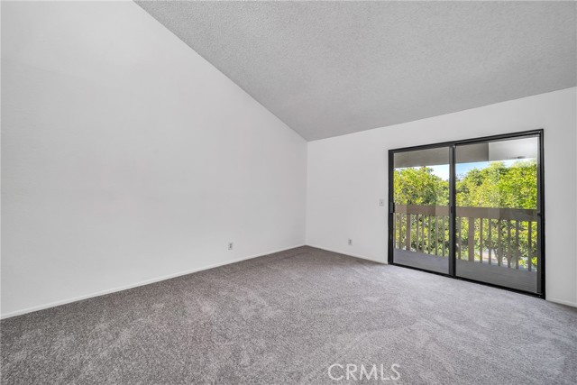 Master bedroom has vaulted ceilings and access to balcony.