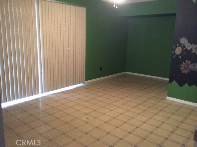 Master-sized downstairs bedroom with large sliding glass door to the patio.