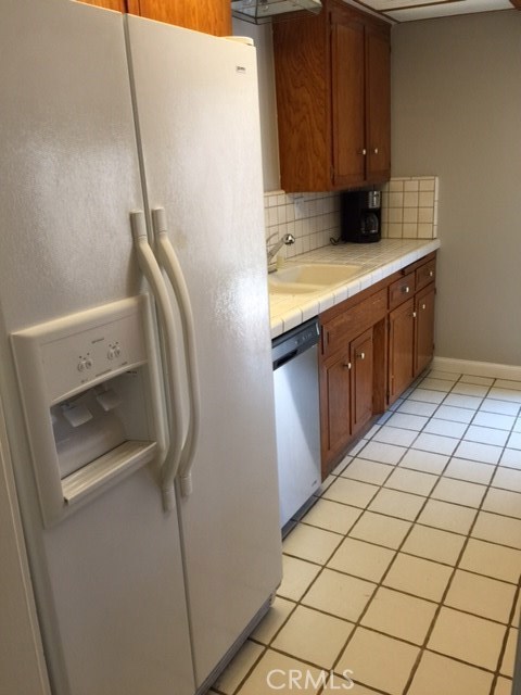 Front house refrigerator, tile floor, dishwasher