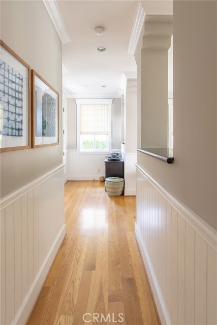 crown molding and wainscoting help magnify the beauty and pristine condition of this home