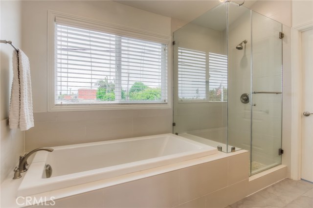 Master bath with soaking tub, frameless glass shower enclosure.