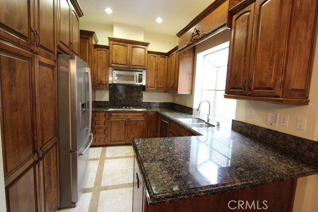 Bay windowed kitchen to bring the outdoors in. Accent and recessed lighting. Kitchen-aid appliances. Five-burner stove, double oven. Vented exhaust hood, contour edged granite countertops.