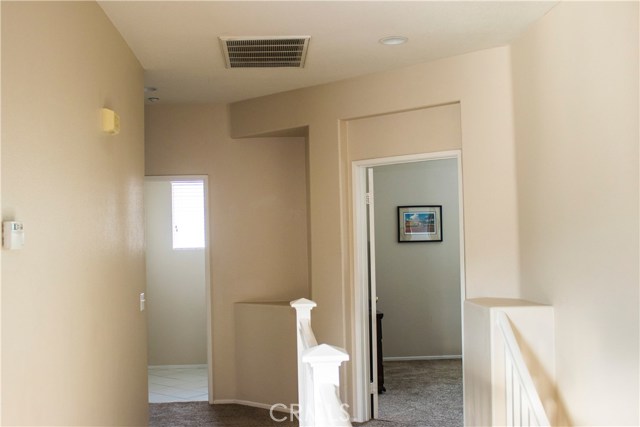 View from hall to master bedroom and laundry room. Upstairs laundry room, yeah!.