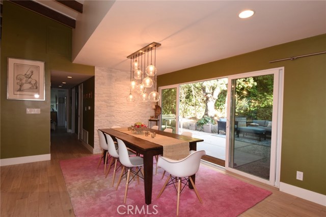 Gorgeous formal dining room with stunning lighting, and sliding door to huge side patio for entertaining!