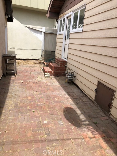 Brick patio between the house and garage.