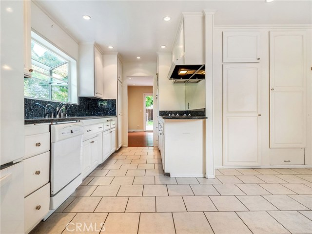 The kitchen with a large breakfast nook and ample cabinetry and pantry space.