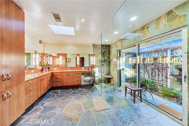 Spacious master bath features dual showers which lead to a private outdoor alcove.