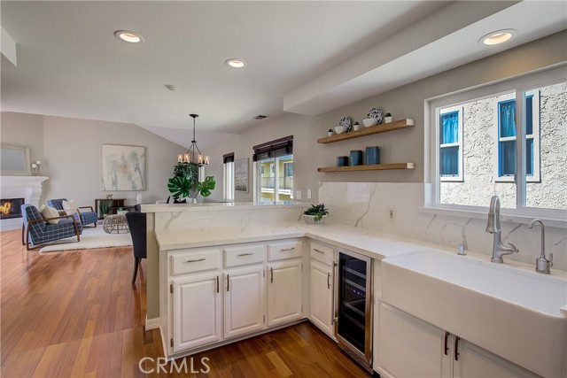 Great shot of kitchen, Dining room and living room in background with cozy fireplace!