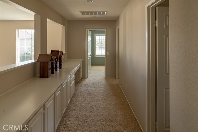 Upstairs hallway with lots of cabinets and desk area