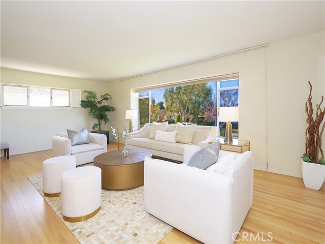 Beautiful hardware floors in living room  with huge window with some ocean view