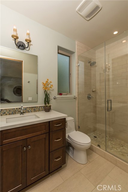 Beautiful attached bathroom to bedroom #2.  Pretty walk in shower, and quartz countertops with pretty tile backsplash.