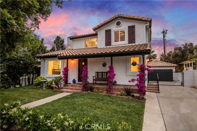  A drought tolerant yard with lush landscaping leads you to a talavera tiled porch from which you can appreciate the hand-crafted entry door and shutters made of reclaimed Douglas fir adorned with hand-forged iron details