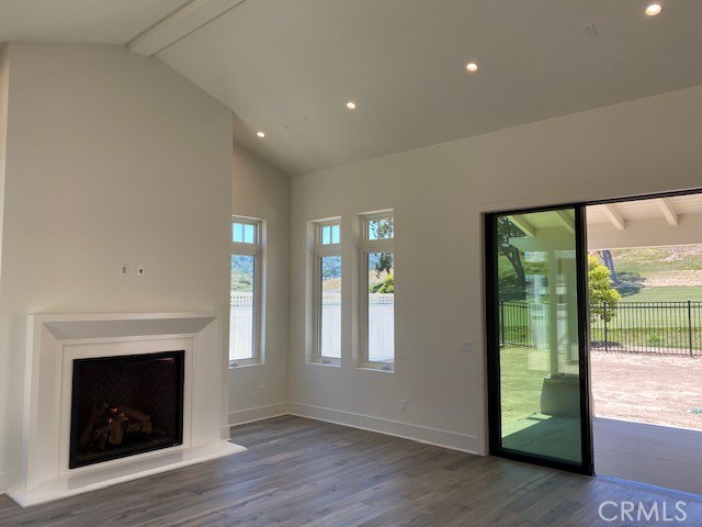 The Great Room has an extra high 15-foot vaulted ceiling. The gas fireplace makes for cozy evenings enjoying the view.