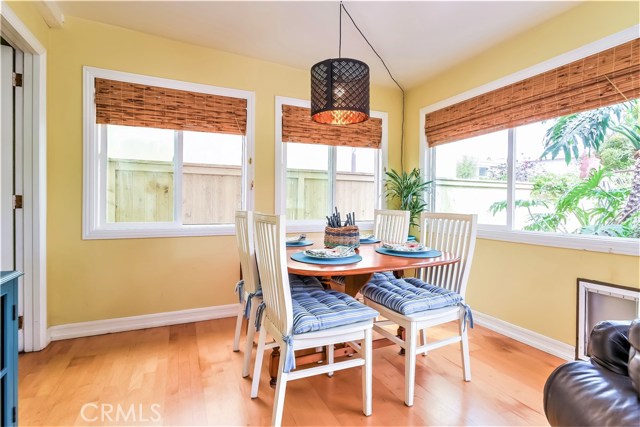 The family room dining area is brightened by the surrounding windows