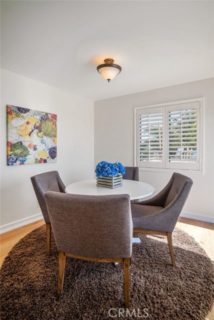 Comfortable sun-filled kitchen eating area with double doors leading to the large deck space.