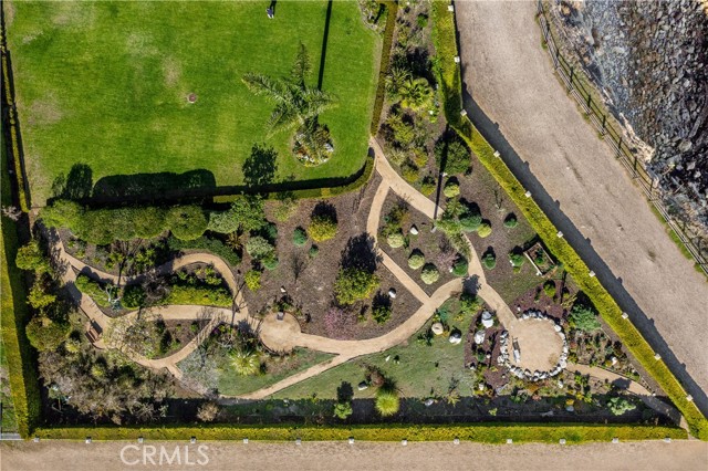 Aerial view of back of property with paths to succulent garden and back gate, leading to walking trail.