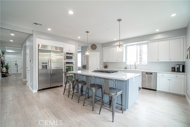 Open floorplan, kitchen island and stainless steel appliances