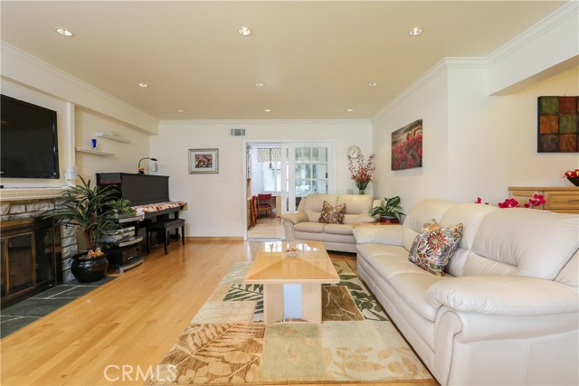 Living room with fireplace, gleaming maple floors