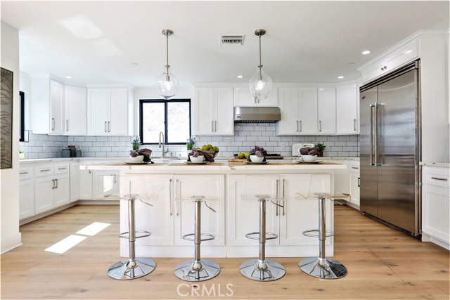The Spacious, Open Concept Gourmet Kitchen has Abundant Storage, Work Surfaces and Seating.