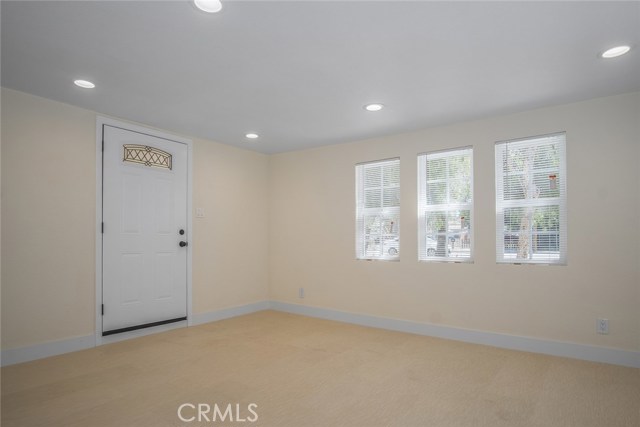 Living room has new laminate flooring with recessed lighting and many windows making it nice and bright