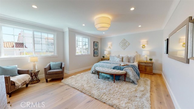 This is the masterbedroom suite on the 1st floor. Look at the size of this suite! oak floors are carried in from the rest of the house, lots of light and spaciousness. The brass wall sconces highlight the bed wall.