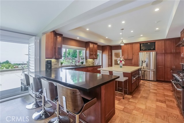 Beautifully remodeled gourmet kitchen (2014) top of the line appliances, Caesar stone counters, ocean, city lights, and mountain views form the picture window and the sliding glass doors.