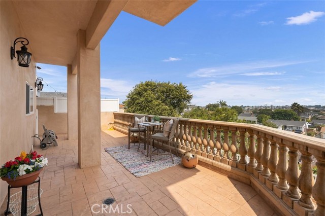 Main floor deck off of kitchen overlooking tiered back yard, city and mountains.