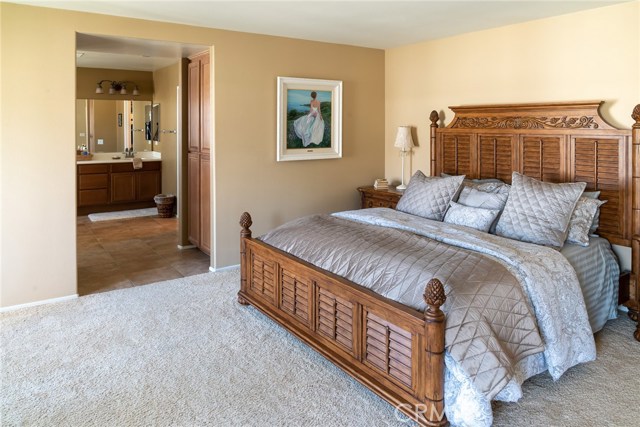 Master bedroom with linen cabinets and view into master bath