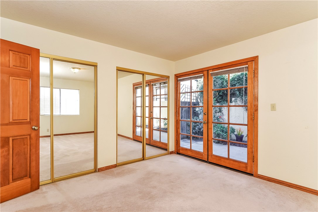 The second bedroom has a wall of closets offering great storage. This room could also be a great in-home office or den with the rear yard access.