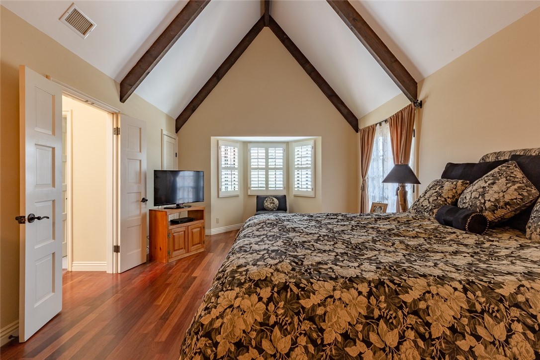 Master bedroom with cathedral ceilings.