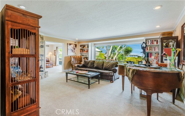 Living Room with coastline views and pool