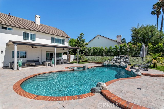 ENJOY THE BEAUTIFUL POOL AND SPA WITH A RELAXING ROCK WATERFALL DIRECTLY INTO THE POOL.
