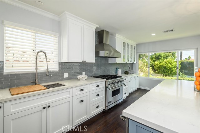 Totally remodeled open kitchen features white shaker cabinets, quartz counters, Viking appliances, huge center island.