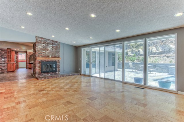 Another view of living room with fireplace and outdoor living areas