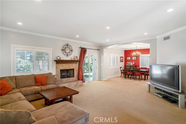 Large living room w/canned lighting & fireplace... relax & enjoy.  Wood Floors are under Existing Carpet!