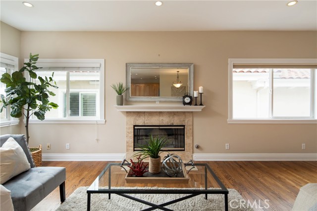 The living room with some views to the ocean features warm natural oak hardwood floors, gas fireplace, recessed lights, and pre-wired for media above the fireplace.