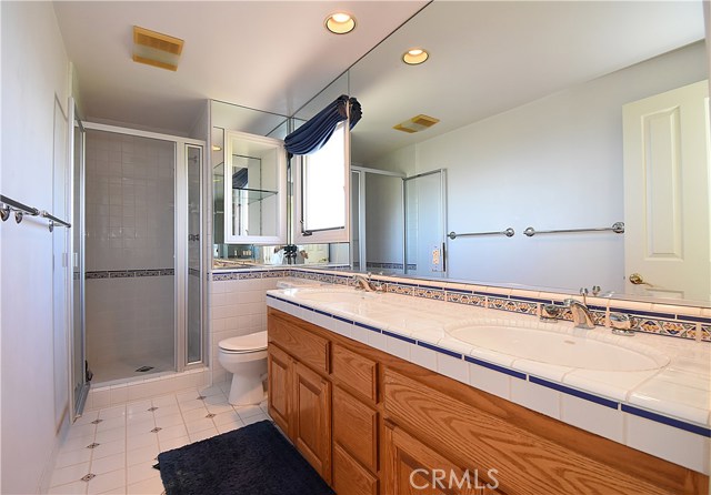 Bathroom upstairs has double sinks, and enjoys coastline views.