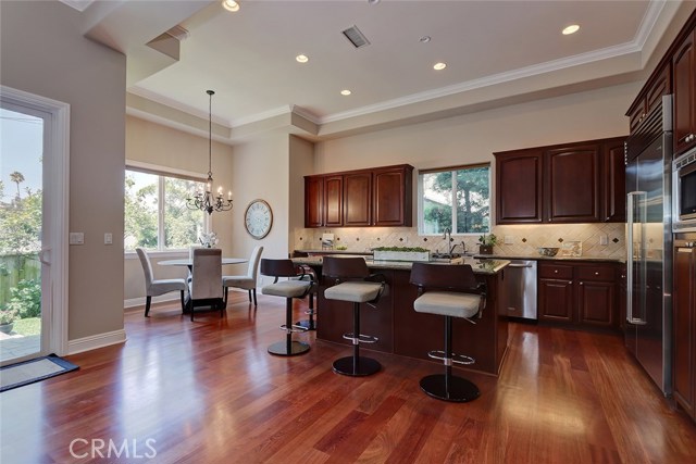 The kitchen is the focal point of your entertaining space, centered around a lovely stone island, beckoning family and friends to gather.