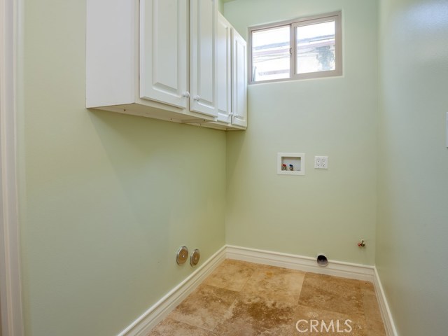 Laundry space on entry level has washer and dryer hookups and storage.