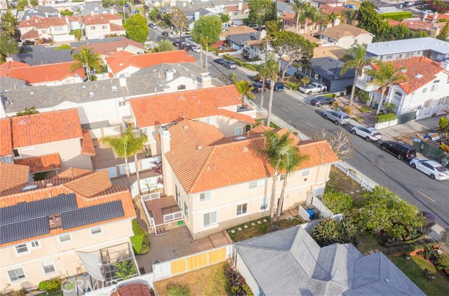 Aerial view of larger than average lot with view of deck, patio, grass area and gated access to enclosed front yard