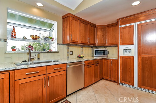 The kitchen has custom cabinetry with pull out shelving, swivel pantry and spice racks, lazy susan swiveling corner cabinets, soft close doors and a wood paneled refridgerator.