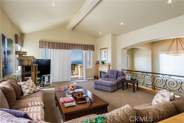 Slightly different perspective of Living Room.  Stairwell from two story entry in on the right, below the iron railing.