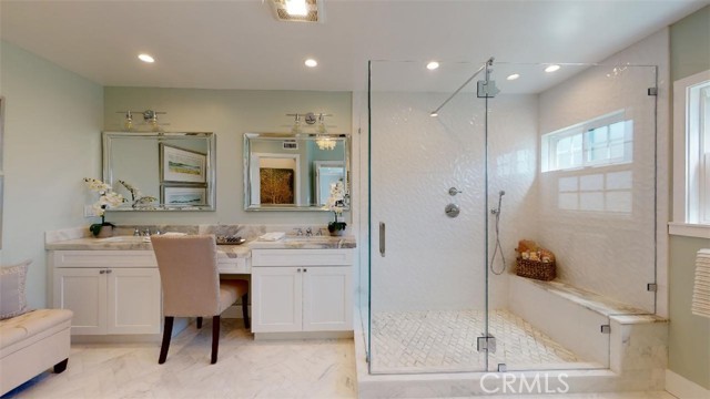 The masterbathroom suite! His and her custom vanities with a soothing color of greens and gray granite counters and shower bench which tie into the granite shower floor. The shower is more a room than a shower.