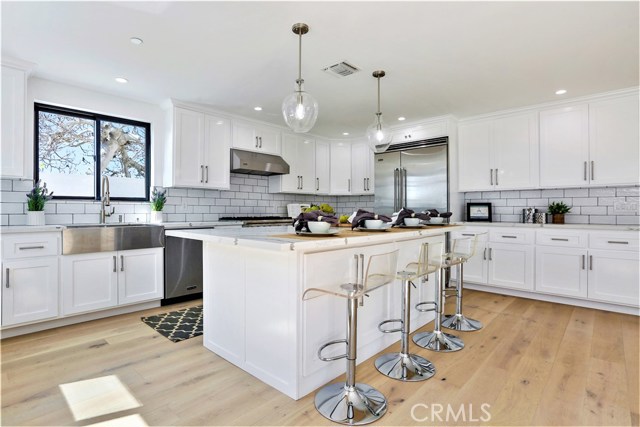 The Large Center Island, Solid Maple Custom Cabinets with Self-Closing Drawers and Doors, 30 ft. of Counter Surface and Top Quality Fixtures are a Gourmet Chef's Delight