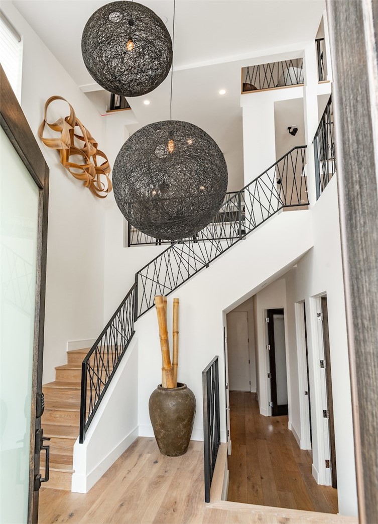 Dazzling entry way with dramatic lighting, soaring ceilings and bathed in natural light