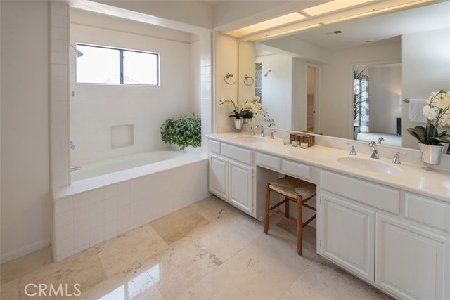 Master full Bath with upgraded travertine floor tile, walk in closet and  cosmetic area!!