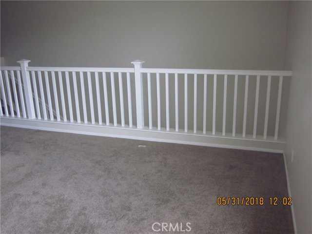 Loft railing, view to downstairs living room and entry.