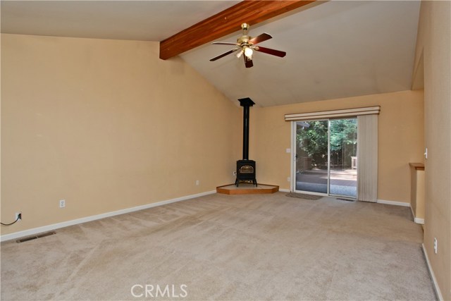 Vaulted ceilings in living room with sliding glass door to back yard